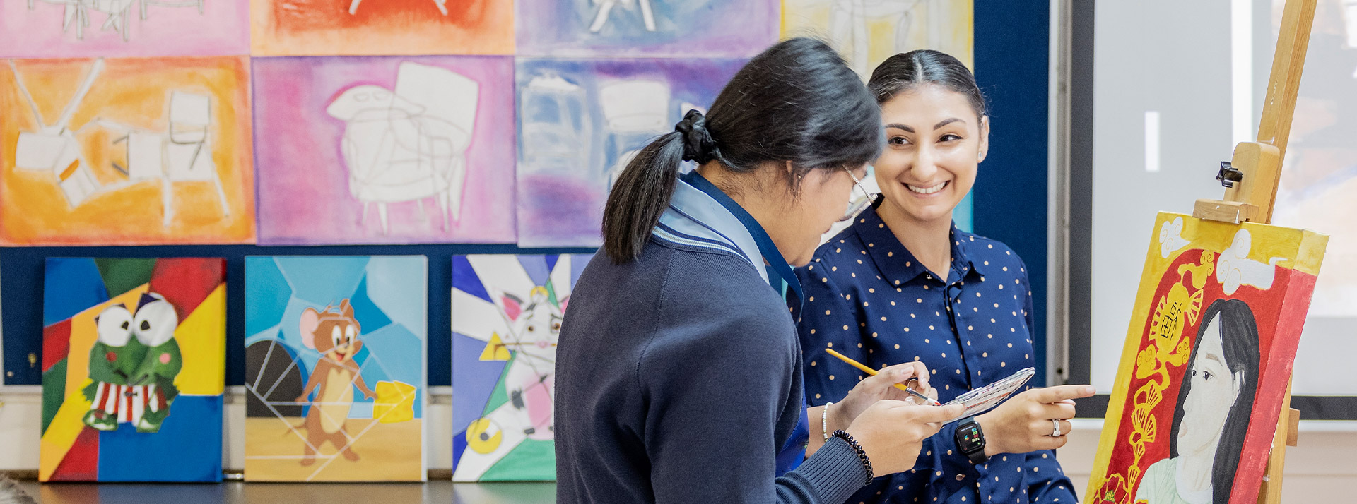 Teacher and her student working on an artwork in the classroom at St Andrews College Marayong
