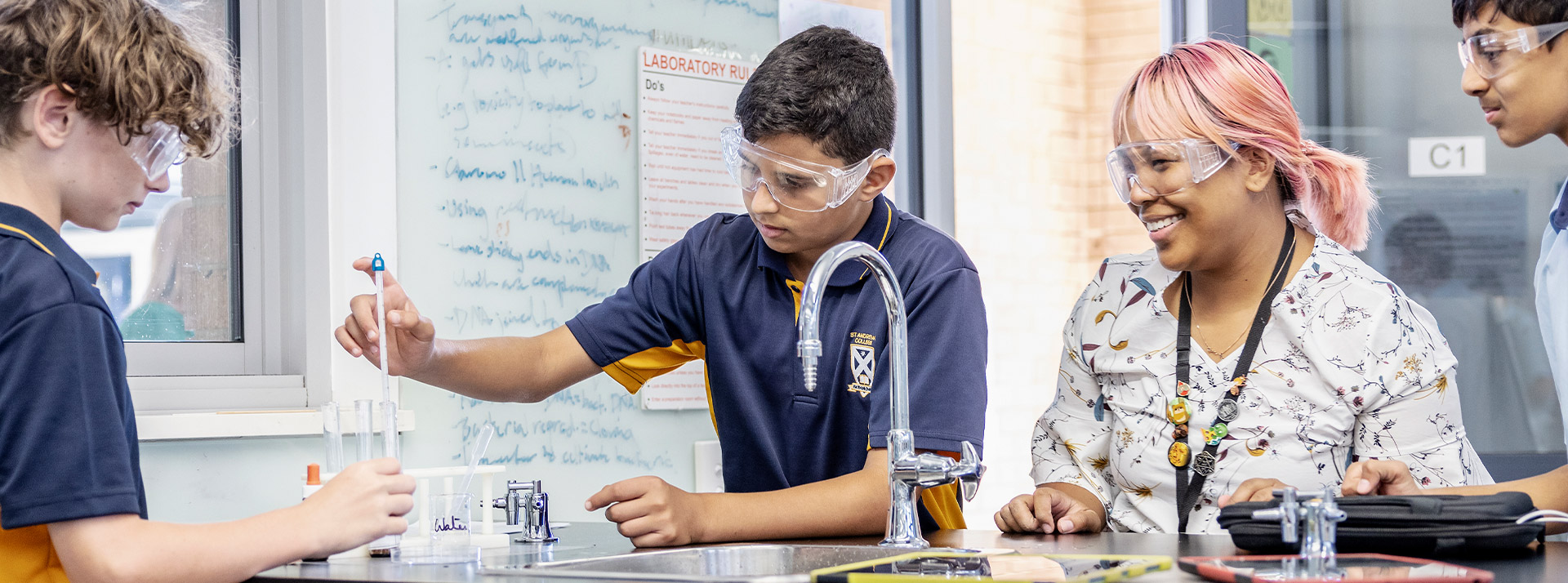 Teacher with her students in the science lab at St Andrews College Marayong