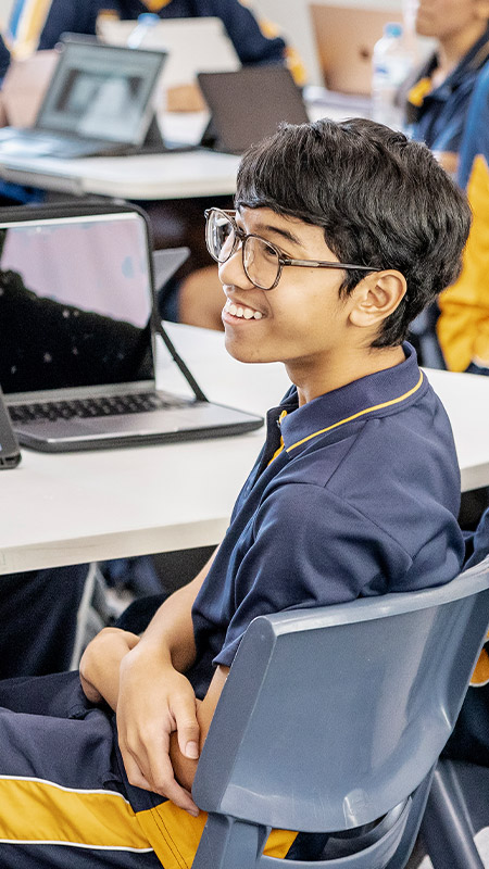 Students sitting at their desks in the classroom at St Andrews College Marayong