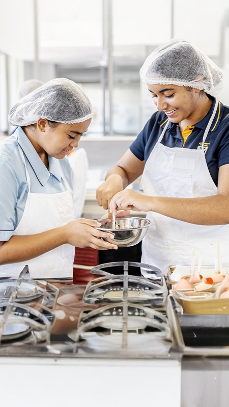 Students working together in the hospitality room at St Andrews College Marayong