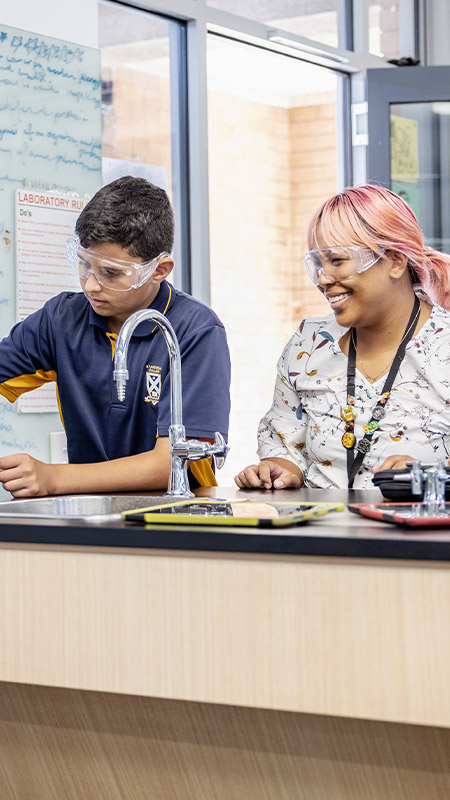Teacher with her students in the science lab at St Andrews College Marayong